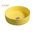 Fregadero redondo de color amarillo con lavabo de cerámica